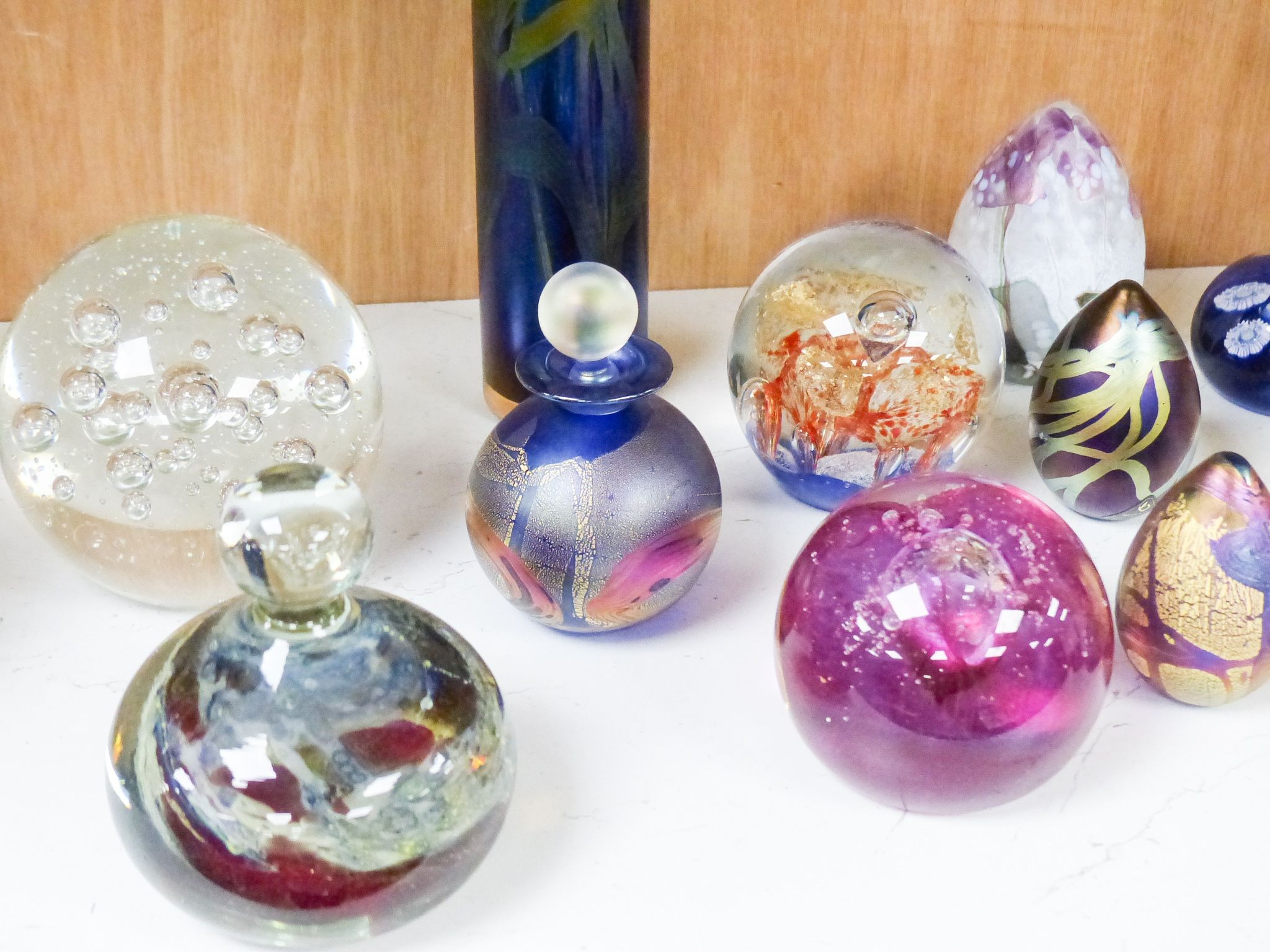 A group of 20th century glass paperweights and studio glass vases, Tallest 24 cm high